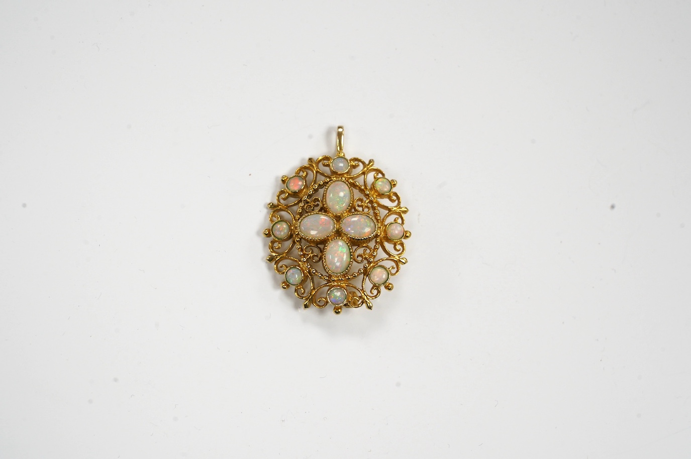 A modern 9ct gold and white opal cluster set oval pendant brooch, 33mm, gross weight 8.7 grams. Condition - fair to good